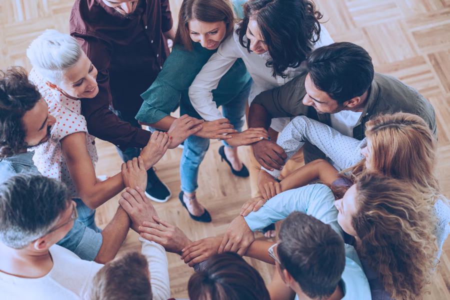 people linking arms in a circle