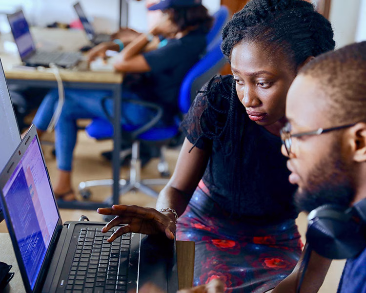 two people working at a computer