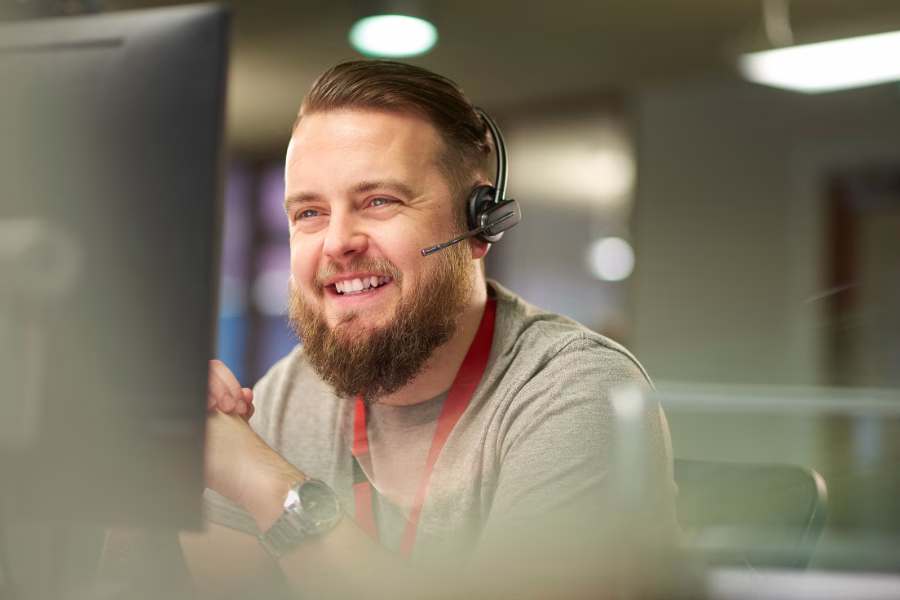 man smiling at a computer